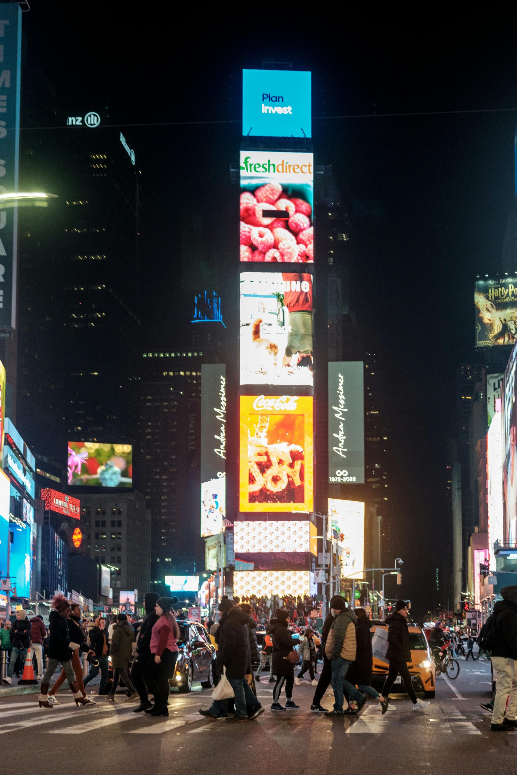 Thriving nightlife at Times Square with bright lights and bustling crowds in New York City.
