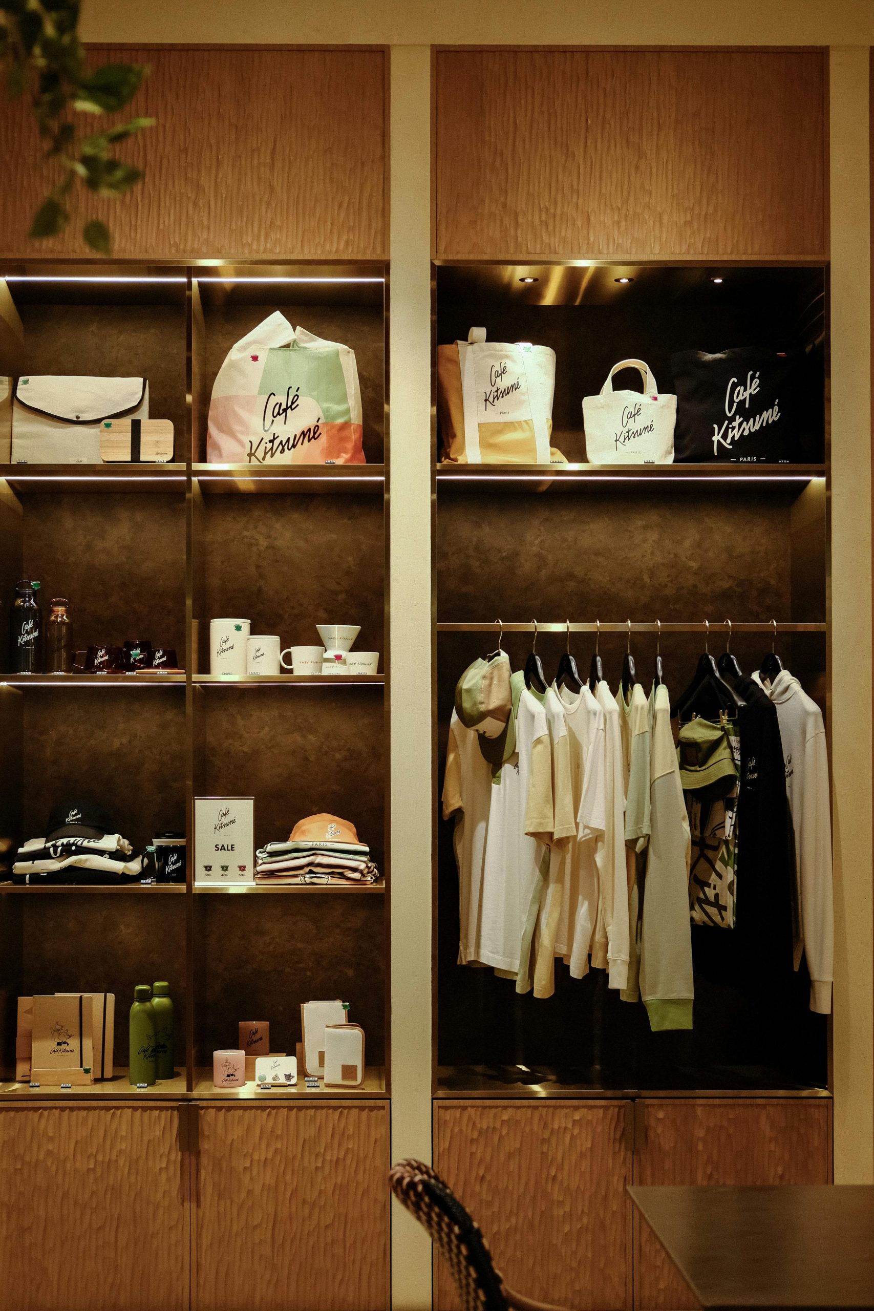 A stylish boutique display featuring clothing, bags, and accessories, offering a modern retail experience.